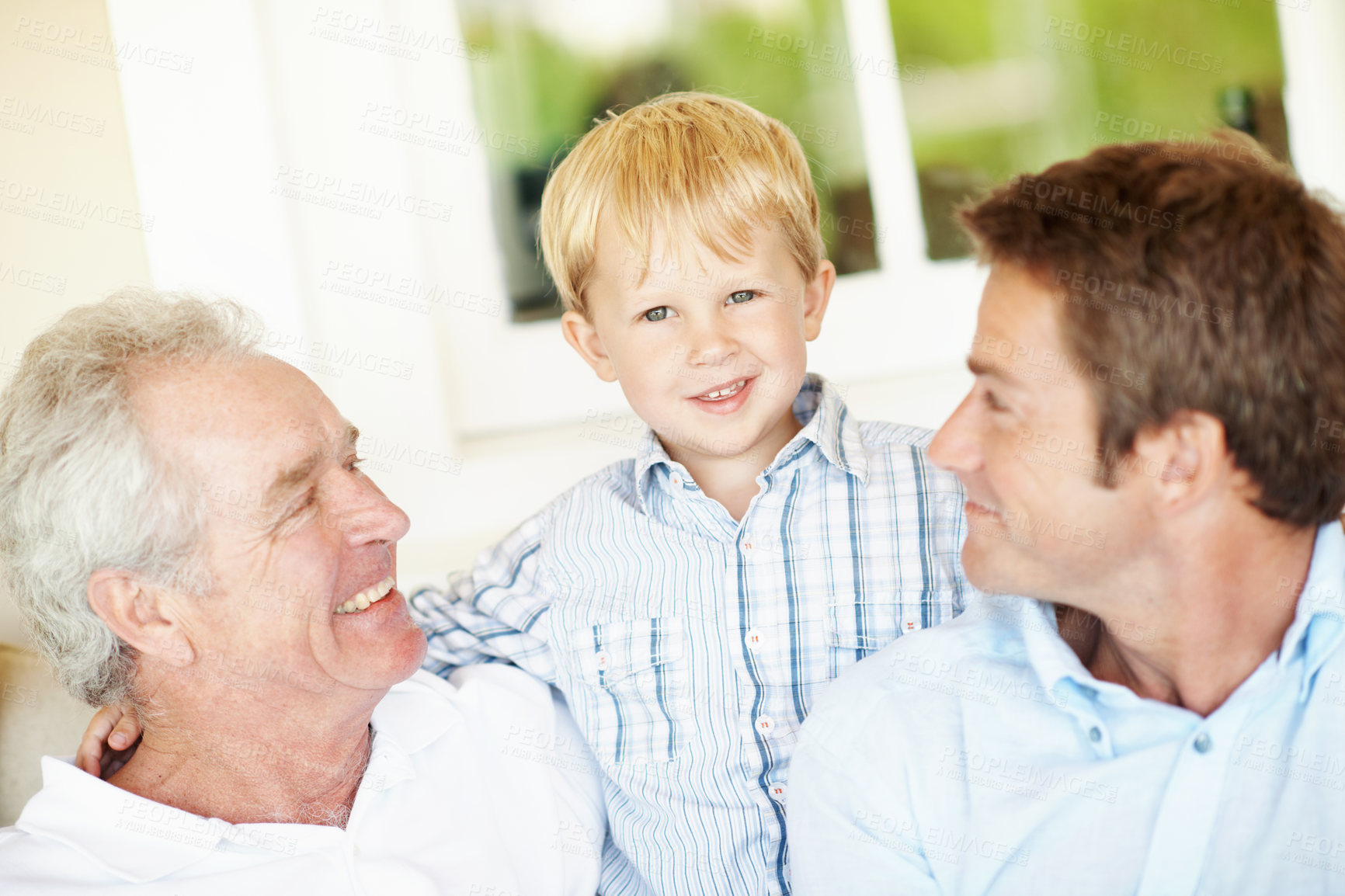 Buy stock photo Family, bonding and grandpa with child in home, generations and connection with grandchild in lounge. Senior man, love and people with smile for kid, portrait and fathers day celebration in house