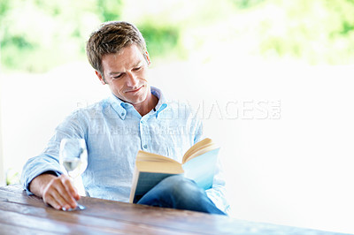 Buy stock photo Reading, book and happy man with wine glass, relax and learning with novel and literature on weekend. Fiction, reader and person with alcohol on break, smile and chill with story or entertainment