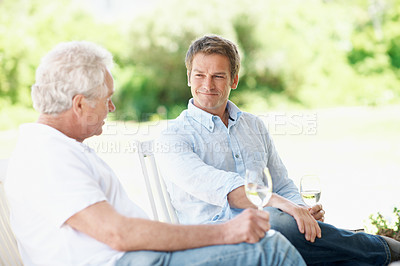 Buy stock photo Wine, garden and man with senior dad for bonding, conversation and relax on weekend. Family, backyard and person with elderly parent, alcohol and drinks for connection, relationship and talking