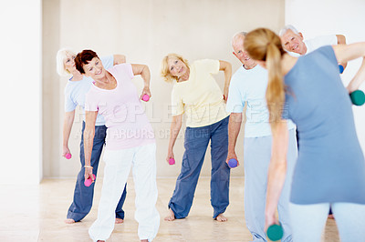 Buy stock photo Class, weights and coach with senior people for exercise, wellness and training for mobility. Retirement, gym and woman with elderly group with dumbbells for health, muscle strength and workout