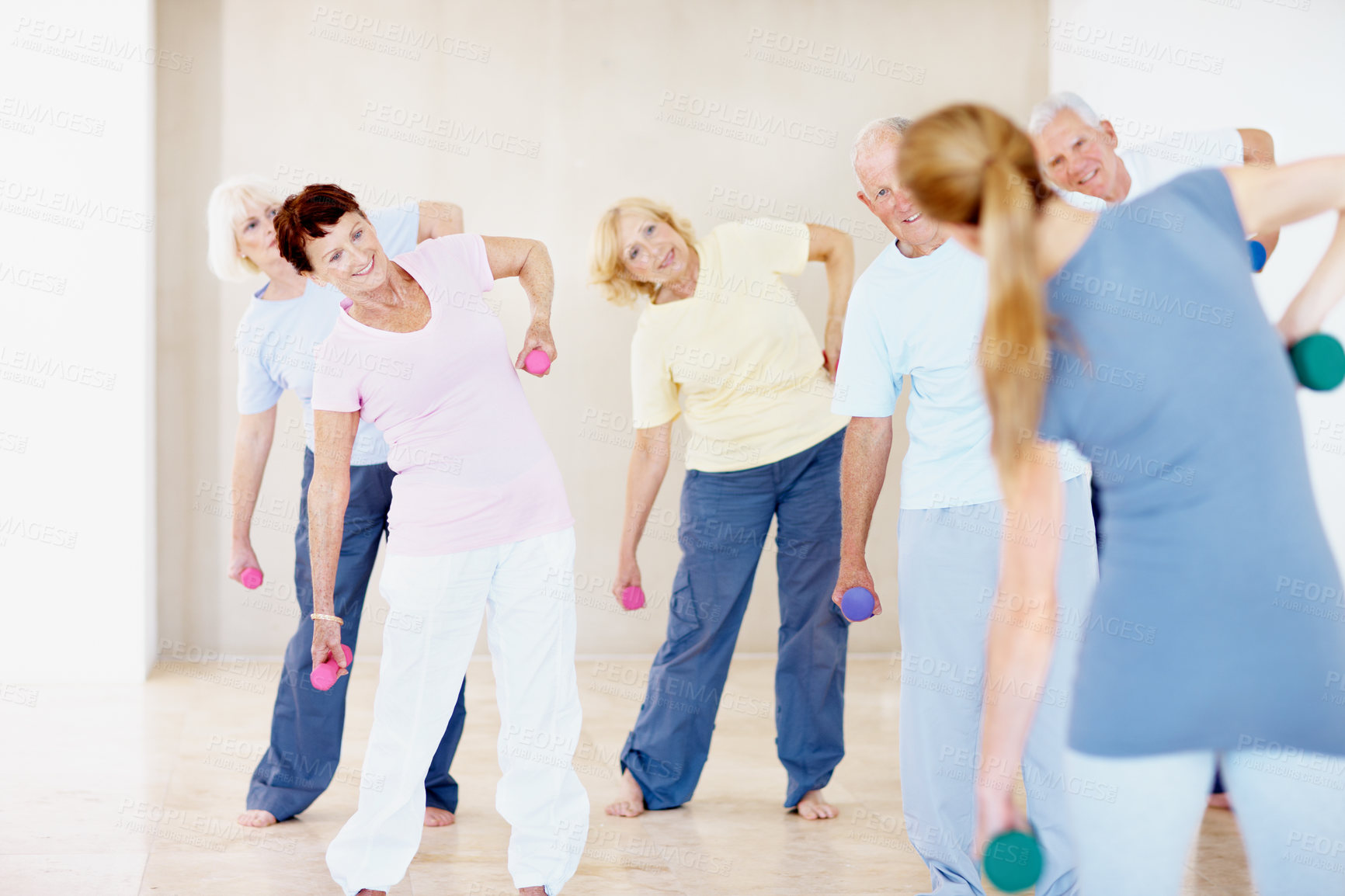 Buy stock photo Class, weights and coach with senior people for exercise, wellness and training for mobility. Retirement, gym and woman with elderly group with dumbbells for health, muscle strength and workout