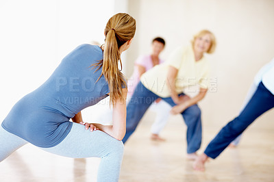 Buy stock photo Fitness, stretching and people in studio with instructor, support and warmup for wellness. Community, personal trainer and lunge at facility for teaching group, muscle development and exercise class