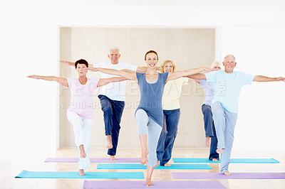 Buy stock photo Yoga class, instructor and senior people with balance for holistic fitness, practice and health. Elderly group, happy yogi and coach stretching with pose, exercise guide and portrait at wellness club