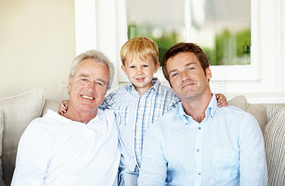 Buy stock photo Dad, portrait and grandpa with child on sofa, generations or bonding with grandchild in living room. Senior man, support and people with smile for kid, family and fathers day celebration in house