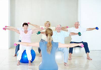 Buy stock photo Dumbbells, exercise and old people with personal trainer in gym for health or wellness. Fitness, retirement and weights with instructor in studio for coaching, physical activity or training class