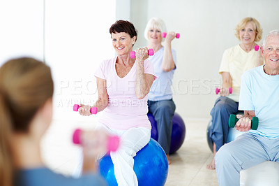 Buy stock photo Dumbbells, fitness group and old people with personal trainer in studio for health or wellness. Exercise class, retirement and weightlifting with instructor at gym for physical activity or training