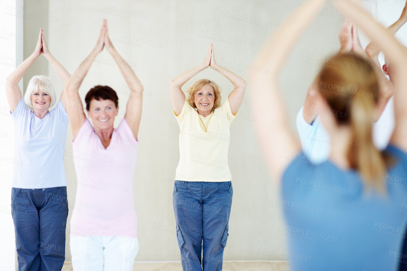 Buy stock photo Yoga class, coach and senior women with prayer hands for holistic fitness, portrait and health. Elderly group, happy yogi and instructor stretching, exercise guide and upward salute at wellness club