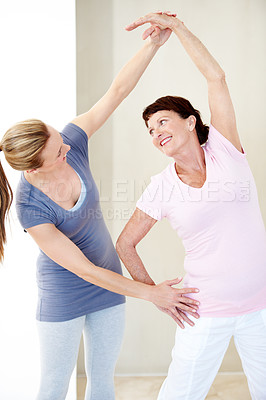 Buy stock photo Smile, coach and stretching with old woman for yoga, fitness and assistance for holistic balance. Happy, instructor and helping senior person with warm up, yogi demonstration and mobility flexibility