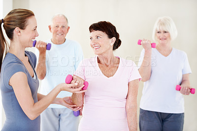 Buy stock photo Pilates, trainer and elderly people in group with dumbbells, support and fitness in retirement. Senior community, instructor and weights at facility for teaching, muscle development or exercise class