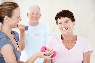 Buy stock photo Pilates, instructor or old woman in class with dumbbells, support or fitness in portrait. Senior resident, personal trainer or weights at retirement home for guide, muscle wellness or exercise group