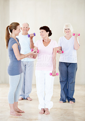 Buy stock photo Pilates, instructor and elderly people with dumbbells for help, support and fitness in retirement. Senior group, trainer and weights at facility for teaching, muscle development and exercise class