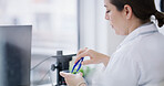 Lab, research and woman with plant in test tube for gmo development, growth or sustainability in science. Biotech, nature and scientist with leaf for study and organic innovation in agriculture