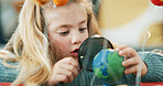 Magnifying glass, science and girl with earth model for project, discovery or assignment. Learning, lens and child with inspection of planet, astronomy or research for school homework in house