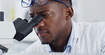 Scientist, microscope or study with black man in lab for forensic research or medical experiment. Serious, male person or microbiologist with biotechnology for science, test results or clinical trial