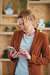 Portrait business woman using smartphone texting on mobile phone browsing messages in office