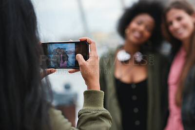 Buy stock photo Travel, picture or friends outdoor with phone screen, group hangout or bonding post on weekend break. Smile, digital photography or people with tech, trip together or memory capture for social media.