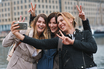 Buy stock photo Friends, selfie or peace sign in city for travel, photography and social media post on holiday. Smile, women or bonding outdoor for profile picture update, getaway reunion and memory on vacation trip