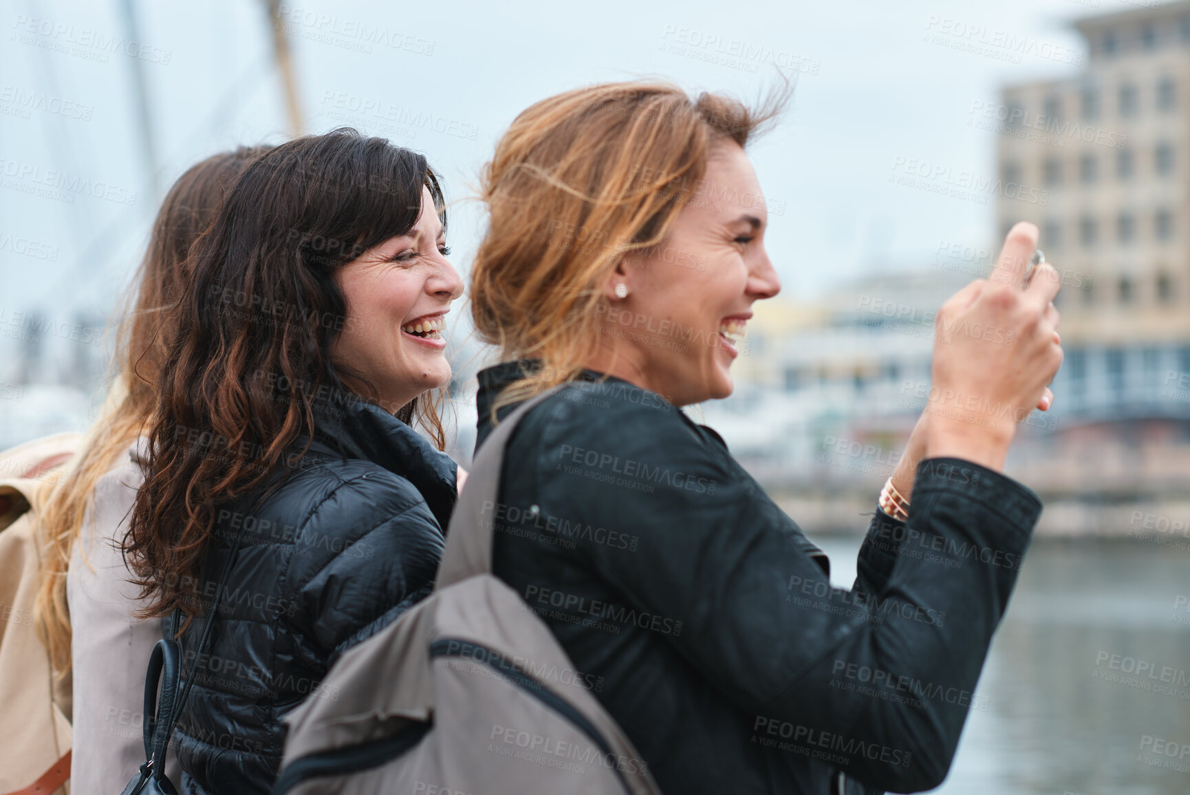 Buy stock photo Travel, picture or friends in town with phone, holiday together or sightseeing post on weekend break. Happy, digital or women in city with connection, bonding trip or tourist memory for social media.