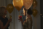 Elegant female friends enjoying cocktails at stylish function