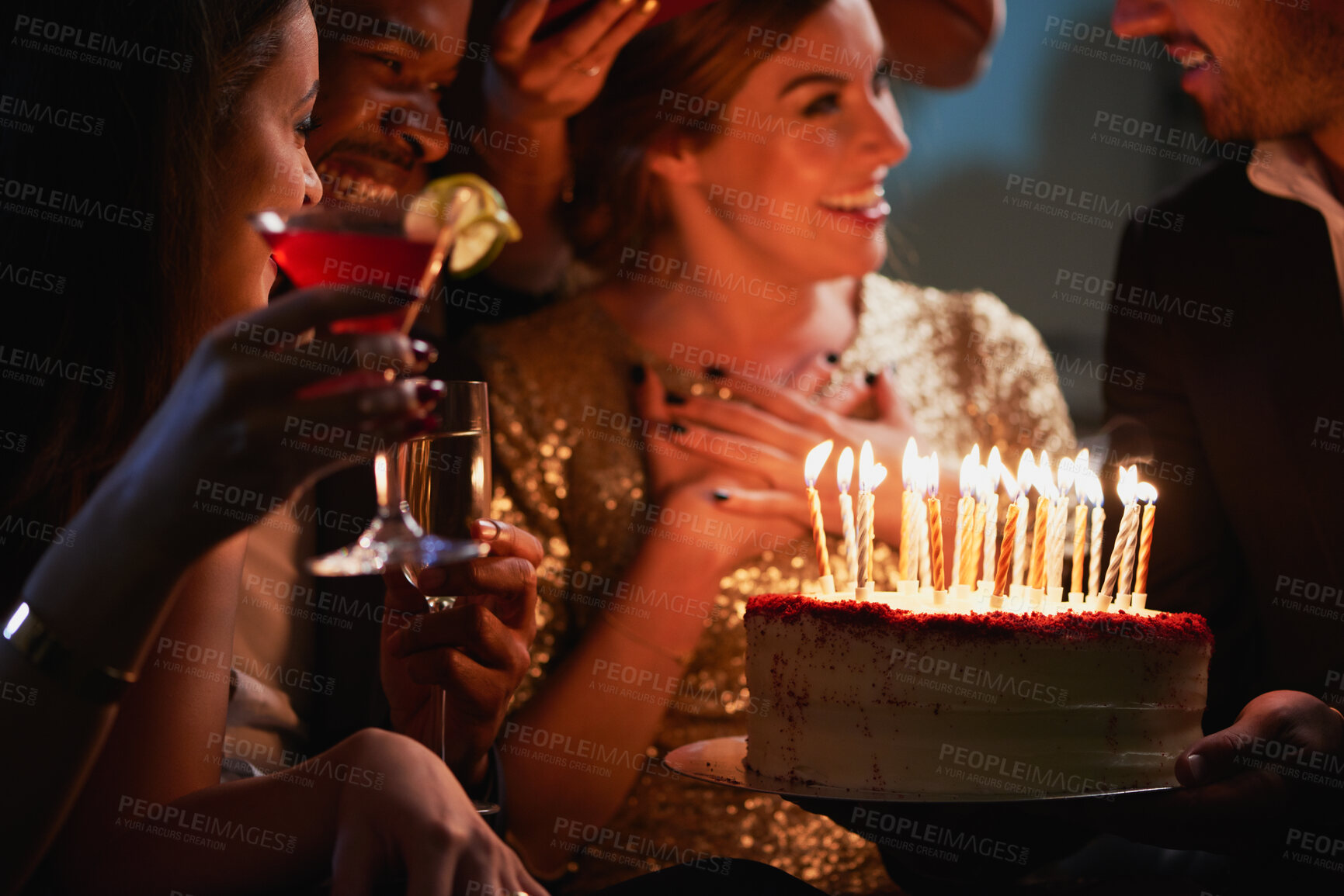 Buy stock photo Night, friends and people with birthday cake at party, celebration and social event for reunion. Bonding, alcohol drinks and happy group with dessert for special day, milestone and late get together
