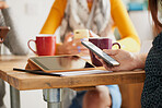 Businesswoman using smart phone drinking coffee at work on break