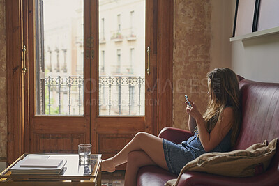Buy stock photo Teenager, relax and girl in home with phone, social media or browsing website for weekend break. Gen z, female person and chat on sofa for communication, download ebook and notification with response