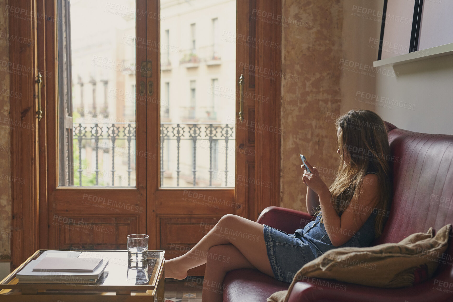 Buy stock photo Teenager, relax and girl in home with phone, social media or browsing website for weekend break. Gen z, female person and chat on sofa for communication, download ebook and notification with response