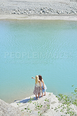 Buy stock photo Back, selfie and friends on cliff for holiday, photography and getaway with social media post. Above, travel and women on coastal ledge with space, profile picture update and quarry water on vacation