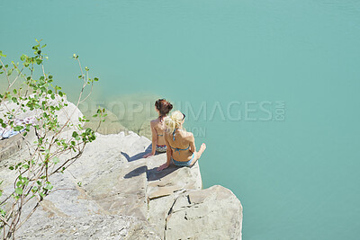 Buy stock photo Back, relax and women on cliff for travel, sunbathing and summer holiday with tropical view. Above, bikini and friends on coastal ledge with space, suntanning and quarry water on vacation getaway