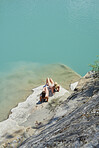 Beautiful girl friends tanning to wild swim in beautiful blue freshwater river on summer adventure vacation in nature