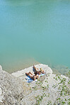 Beautiful girl friends tanning to wild swim in beautiful blue freshwater river on summer adventure vacation in nature