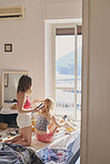 Beautiful Girl friends doing hair with straightener on summer vacation