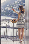beautiful fashionable woman taking photo using smart phone technology at hotel on luxury vacation
