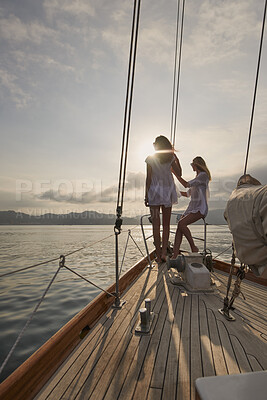 Buy stock photo Women, friends and sail with boat for travel, outdoor adventure or vacation journey on sea. Female people, sailor or tourist with sunshine on yacht for tourism or cruise together on coast in nature