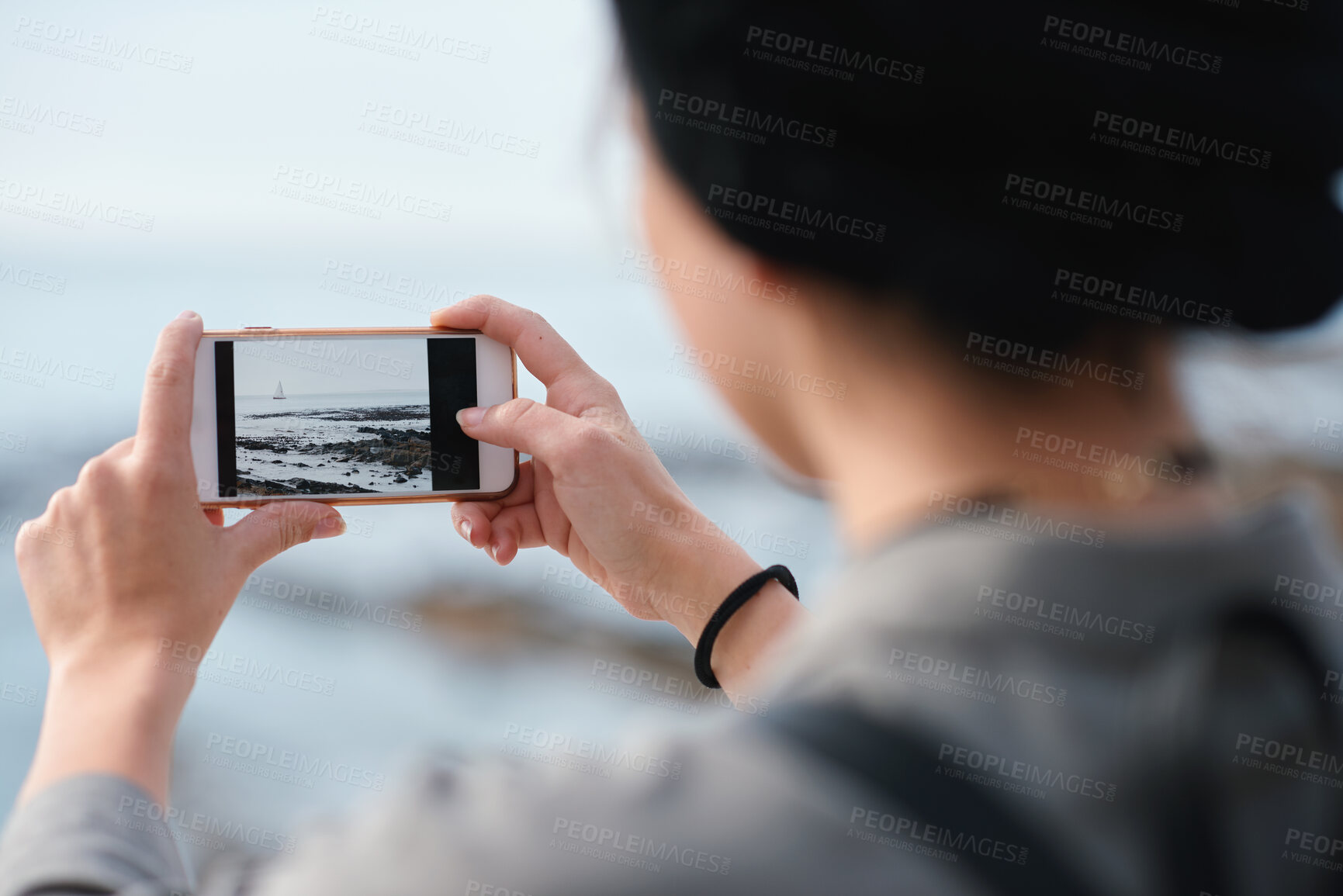 Buy stock photo Outdoor, influencer and hands with phone screen for photography, travel blog and holiday trip. Mobile, tourist or person with beach picture for destination vlog, vacation memory or social media post