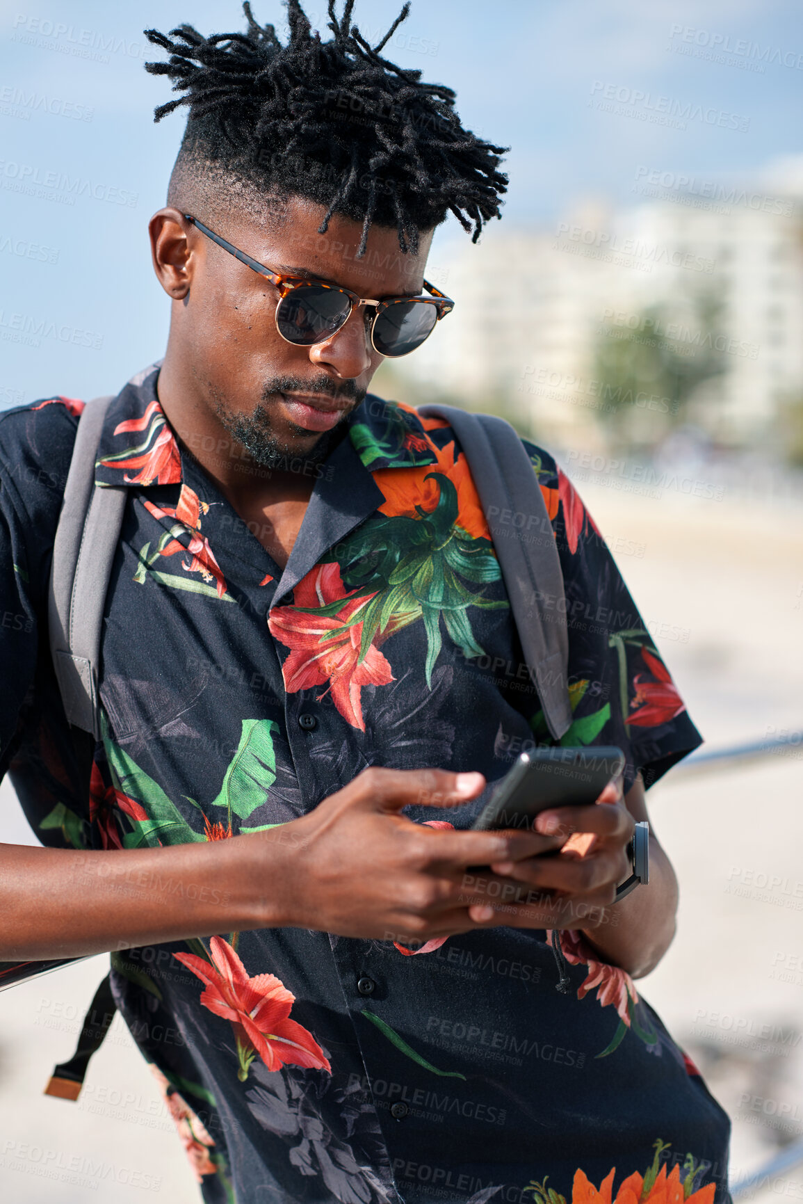 Buy stock photo Phone, travel and black man by beach on holiday for texting, social media or contact on mobile app. Tech, promenade and male person on cellphone for blog on vacation tips on seaside weekend trip.