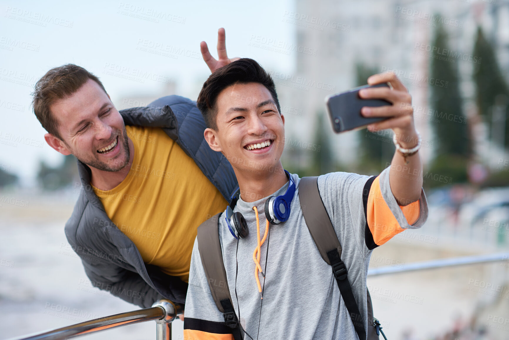 Buy stock photo Selfie, bunny ears or college students outdoor with fun, bonding or friendship post on academic break. Happy, playful or men with connection, university trip or memory capture for social media.