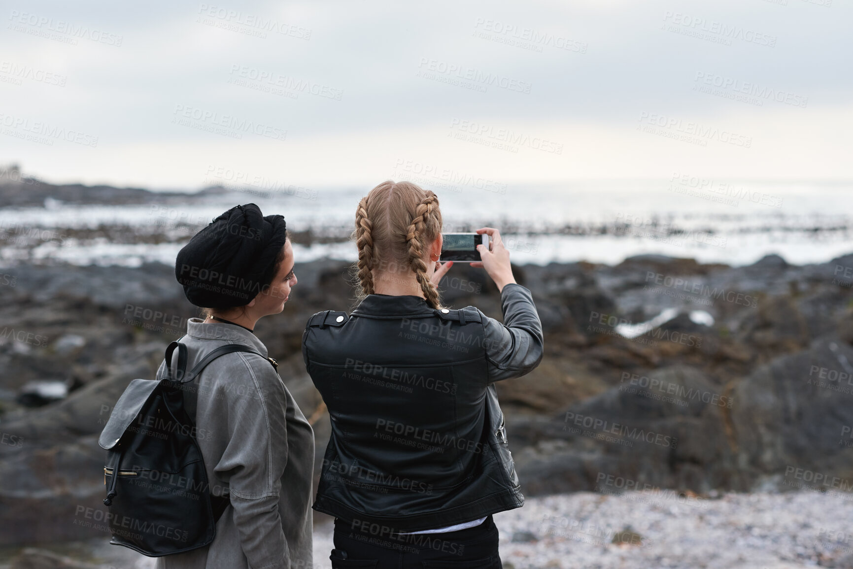 Buy stock photo Beach, picture and women with phone screen, bonding and share memory on social media app or website. Coastline, photo and friends on holiday in nature, space and people with mobile for travel vlog