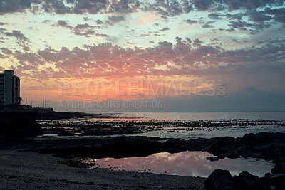 Buy stock photo Rocks, sky and sunset with view of ocean from seaside for background or scenic wallpaper. Clouds, seascape and space with water in colorful environment for calm dusk, nightfall or twilight scenery