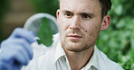 Man, scientist and petri dish outdoor with leaf, research and botany study for medical cure. Bokeh, botanist or analysis with plant sample for agriculture, microbiology and conservation with specimen