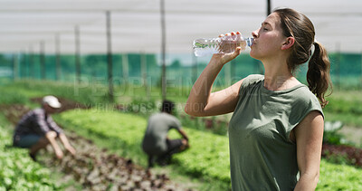 Buy stock photo Woman, farmer and drinking with water in greenhouse for natural sustainability or food production. Thirsty, female person or farming with mineral liquid for hydration, agro business or agriculture