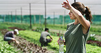 Farmer, woman and sweat with water break for agribusiness, fatigue and hot weather in greenhouse. Tired, person and hydration on farm with sustainable agriculture,  rest and heat from global warming.
