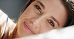 Portrait, woman and lying with smile on bed for comfort, relax or soothing weekend in home. Face, happy and female person with pillow or rest for morning break, calm holiday or recovery in house