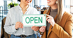 Hands, open and sign with women in small business boutique for commerce or retail. Collaboration, glass door and smile with happy people at shop entrance for management as owner team of startup store