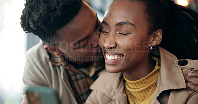 Buy stock photo Love, black couple and kiss with phone in cafe for romantic date, text message and web browsing. Trust, people and affection with mobile app in coffee shop for social media, status update and loyalty