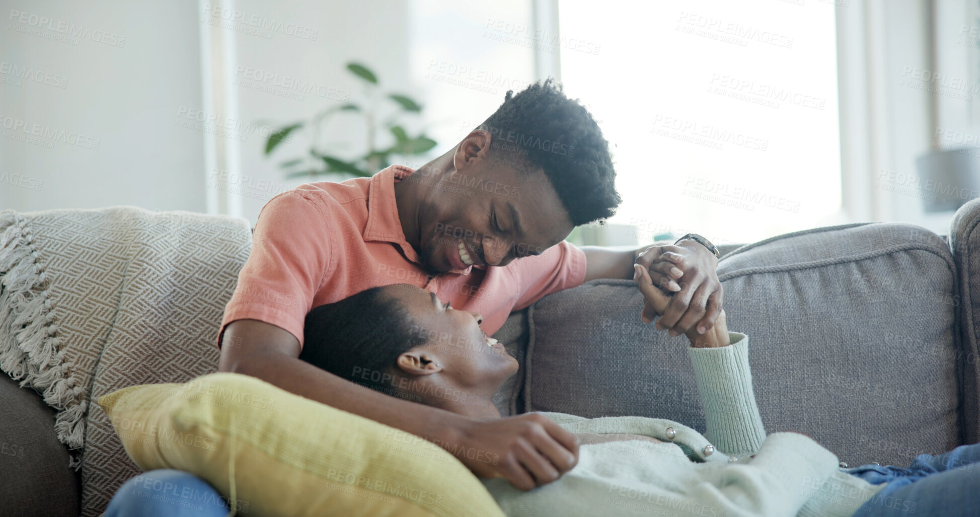 Buy stock photo Couple, relax and holding hands on couch with smile, commitment and bonding together for connection. Happy, black people and dating with love for caring relationship, loyalty and support in home.
