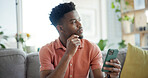 Thinking, cellphone and black man on sofa in home with networking, connection or texting on mobile app. Relax, decision and African person with cellphone for chatting, communication or social media.
