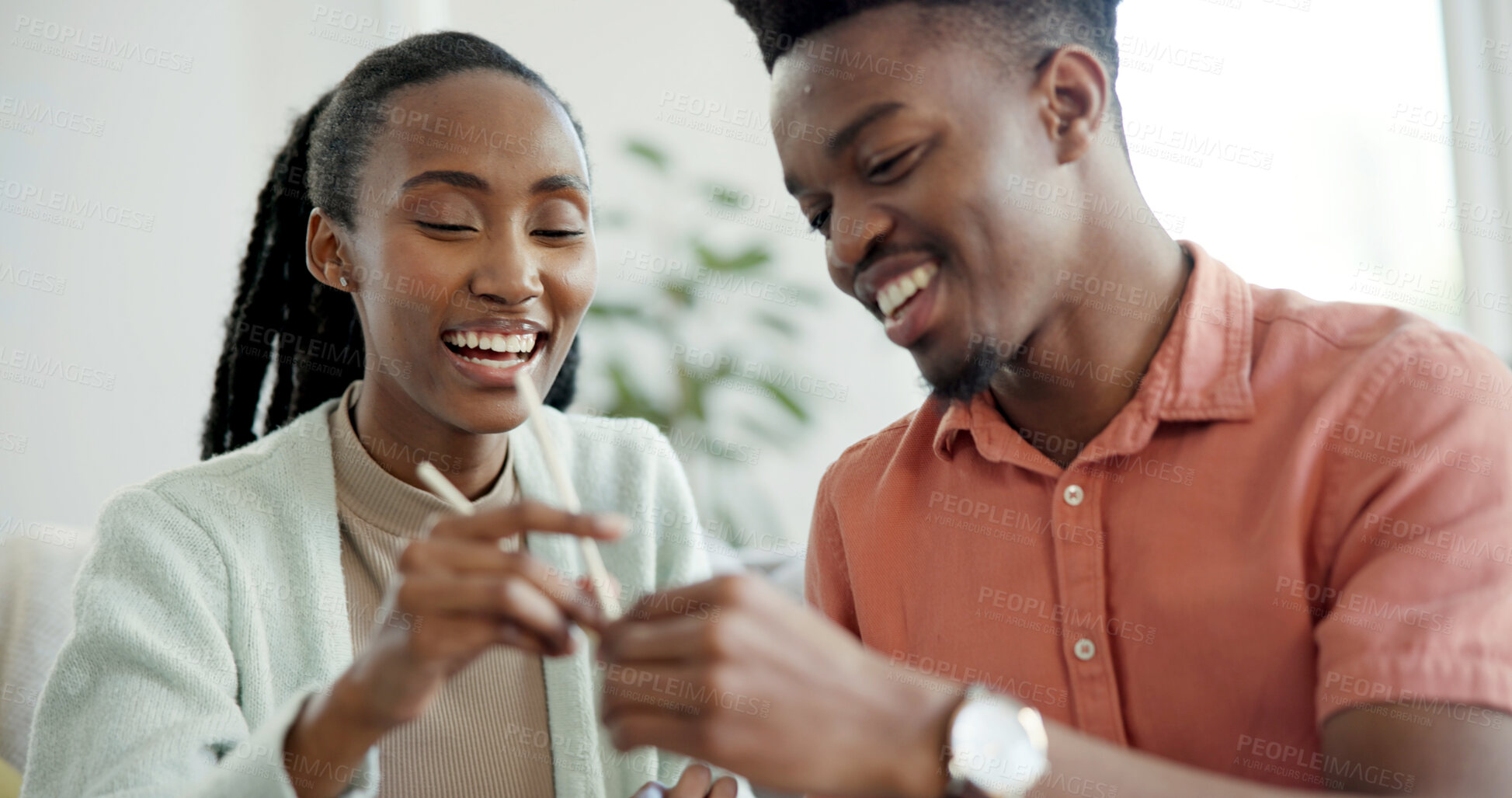 Buy stock photo Smile, couple and learning at house with chopsticks, technique and assistance for new skill. Happy, black people and help with sticks for dining etiquette, Japanese customs and bonding for tradition