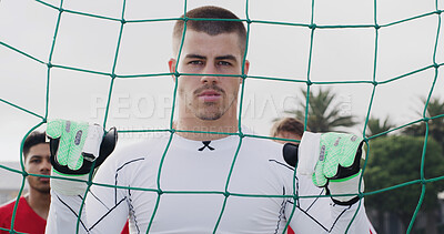 Buy stock photo Goalkeeper, soccer and man by net outdoor for sports, match training or determination for competition. Serious person, football player and goalie for defense, confident and fitness with team portrait