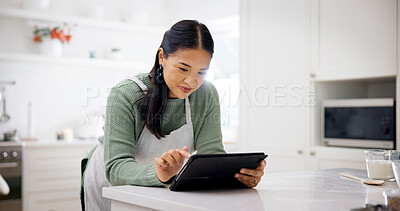 Buy stock photo Cooking, reading and woman with tablet in kitchen, meal inspiration and internet for cuisine tutorial. Research, smile and Asian person with tech for recipe guide, food blog and baking video in home